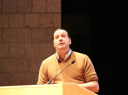 man speaking at podium