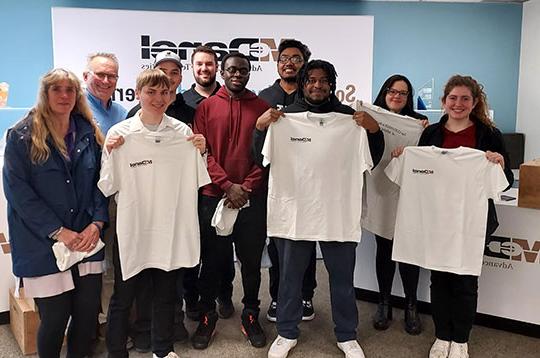 students holding tshirts