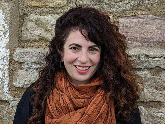 woman with long dark hair and scarf