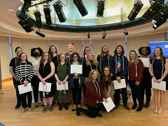 group of people holding certificates